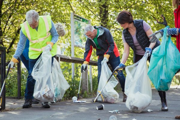 group of people picking up litter