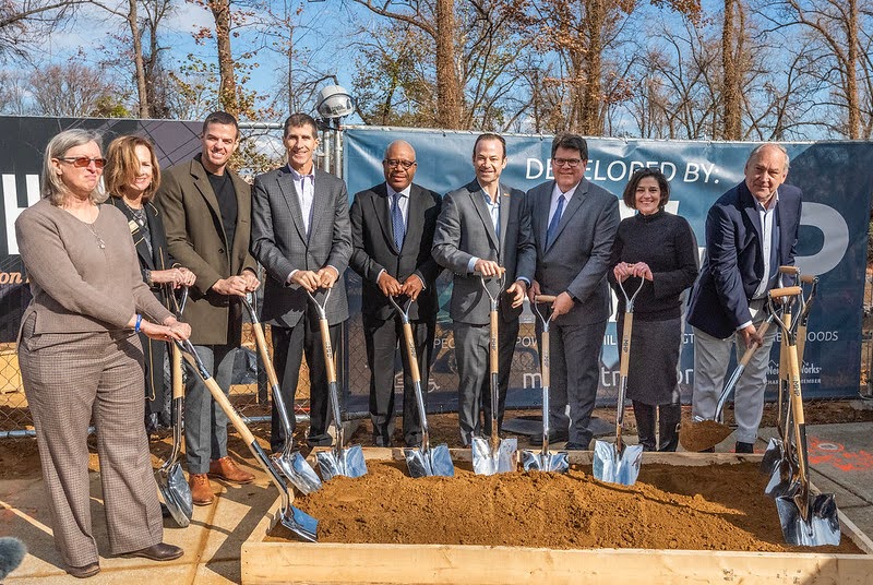 County and housing leaders hold shovels for the Chimes groundbreaking event.