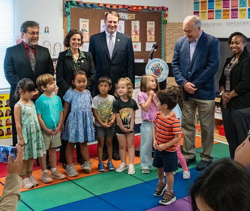 Council President Stewart joins county leaders and students in a classroom.