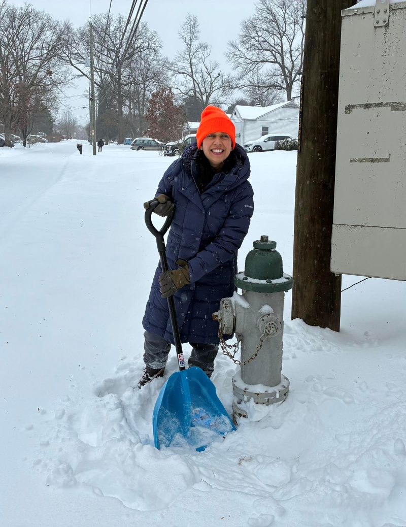 Council President Fani-González shovels snow from a fire hydrant. Removing snow and ice around a fire hydrant ensures emergency responders can view and access the hydrant in case of emergency.