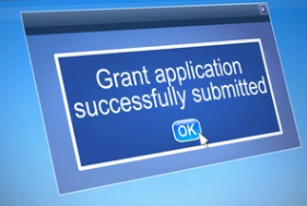 Computer screen with pop-up message ‘Grant application successfully submitted.’