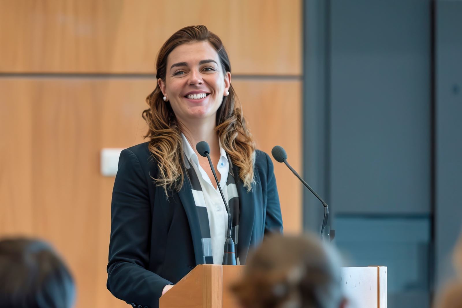 woman smiling at lectern