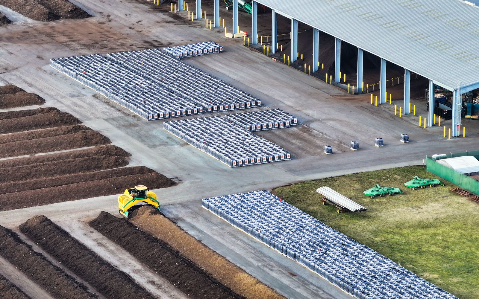 aerial view of yard trim composting rows and bags of leafgro soil amendment