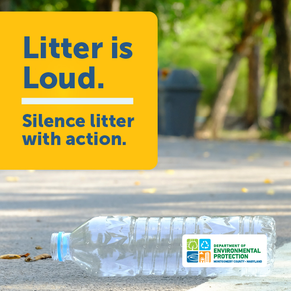 Plastic water bottle in the foreground of path with a trash bin the background.
