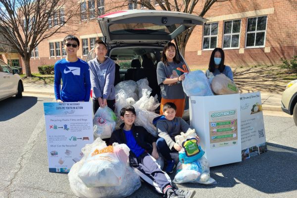student volunteers with full trash bags