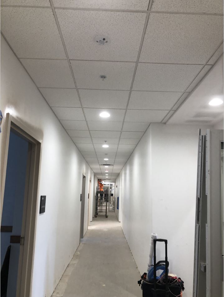 Corridor 139 ceiling grid, tile and lights installed.