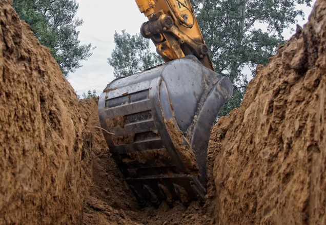 Excavator truck digging a trench