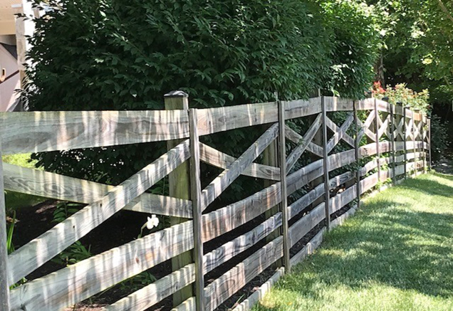 wooden fence in a yard of a single family home