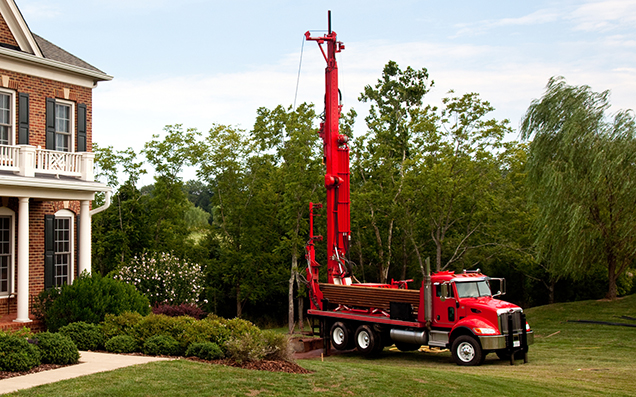 truck drilling a well for a single family house