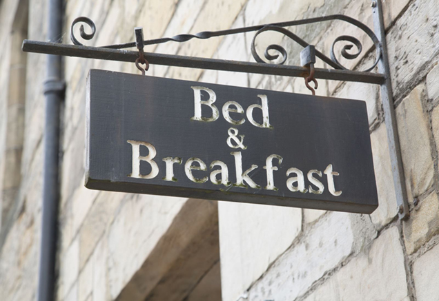 sign on a building indicating that it is a bed and breakfast