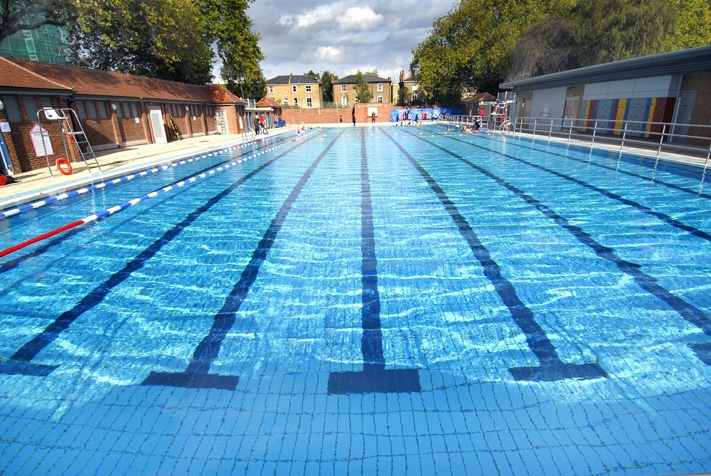 Empty outdoor pool with two lap lanes on a sunny day
