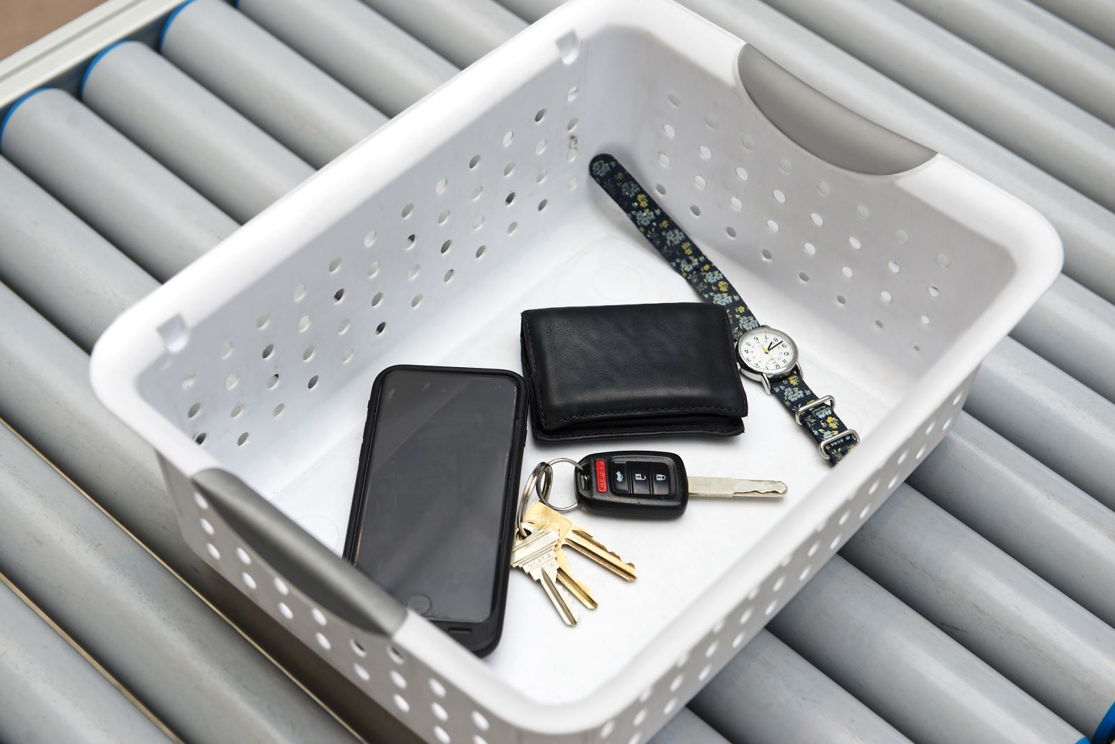 Security basket with phone, wallet, keys, and watch