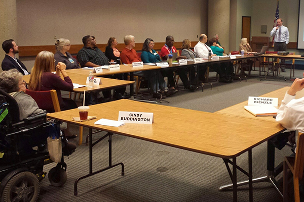 members of the Montgomery County Commission on People with Disabilities sit around a table during a meeting