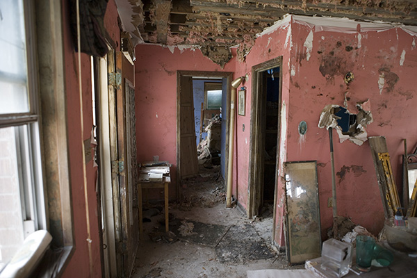 room with damaged and moldy walls after a flood