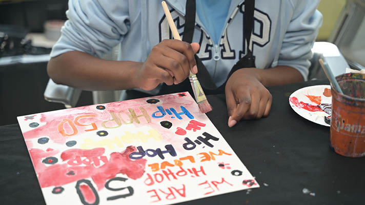 person painting an album cover