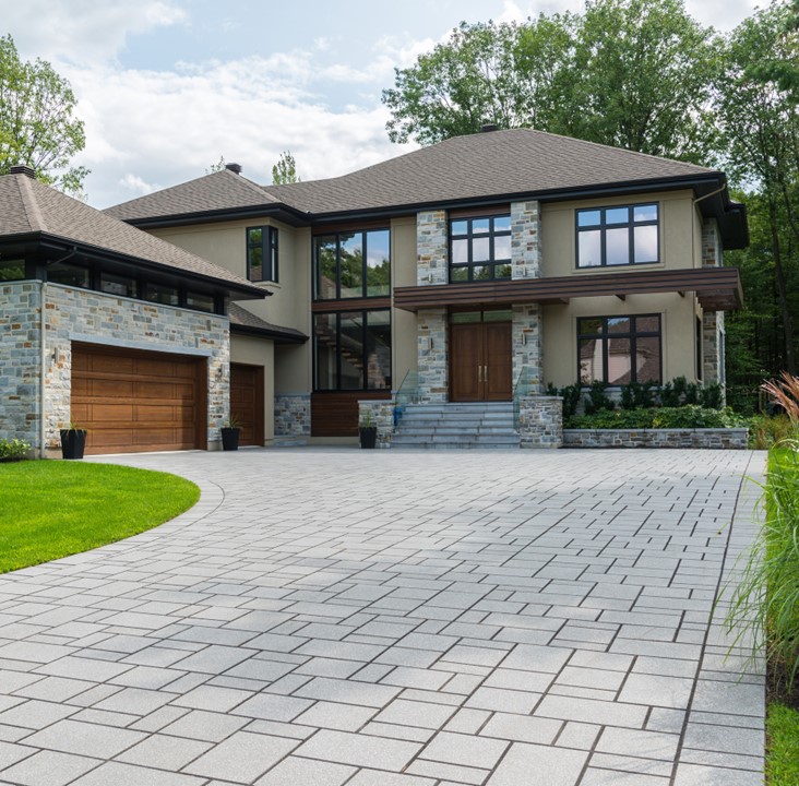 Cemented pathway leading to garage and modern house