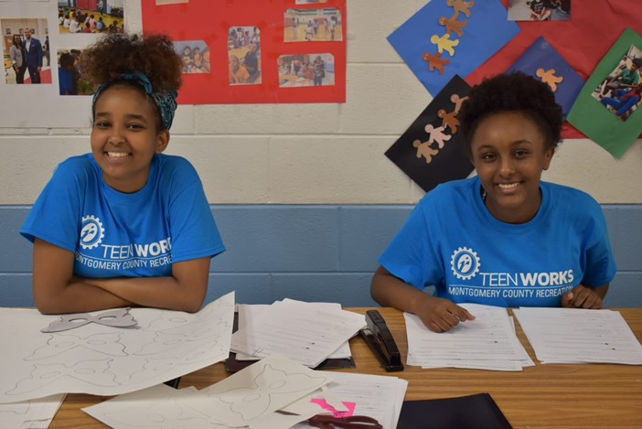 Young ladies from the Teenworks program with blue shirts