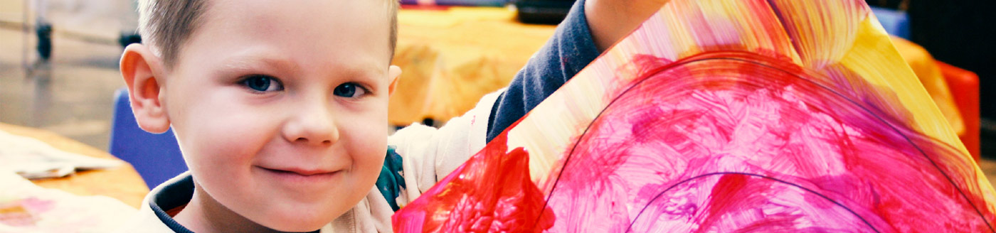 young boy holding artwork