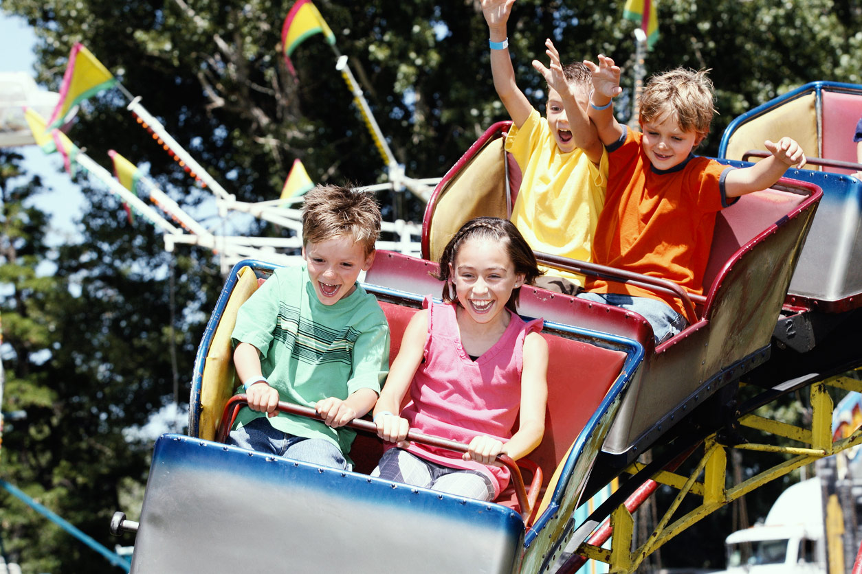 children riding rollercoaster