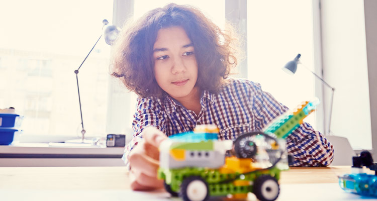 boy with robotic lego creation