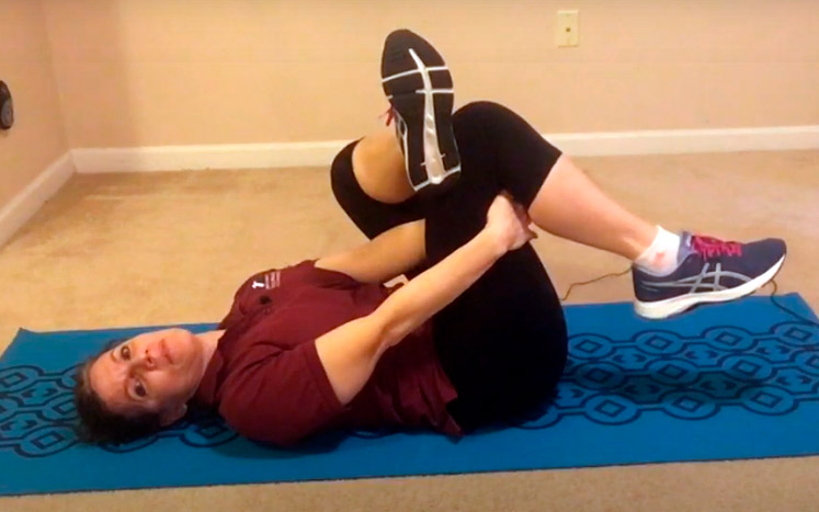 still photo of woman doing floor exercises