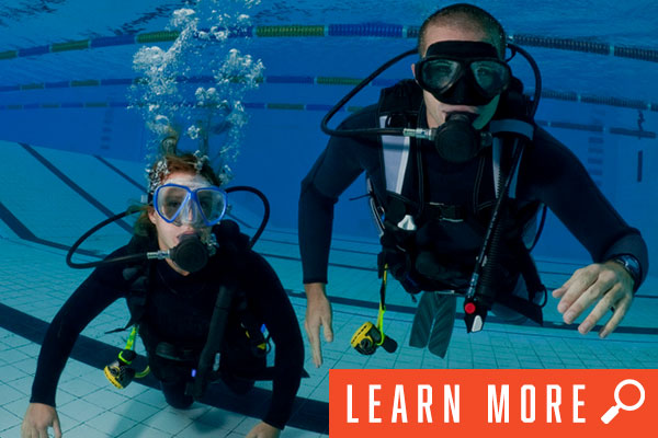 two people underwater in scuba training, click to learn more