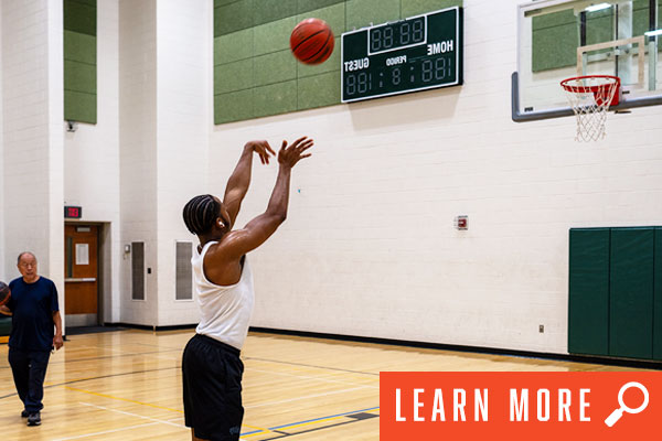 Photo of adults playing basketball. View adult basketball information.