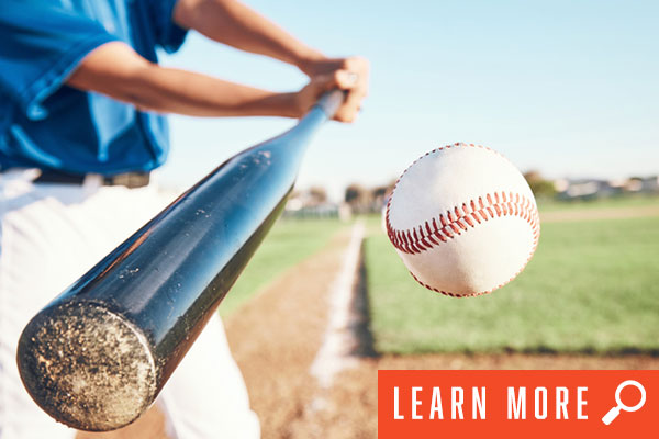 Close shot of softball swing of bat. View softball information.