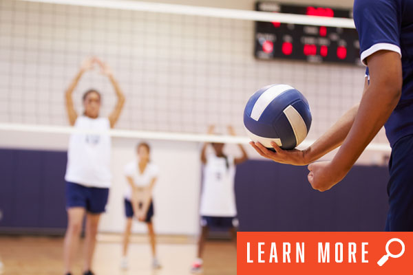 Girls playing volleyball in gym. View adult volleyball information.