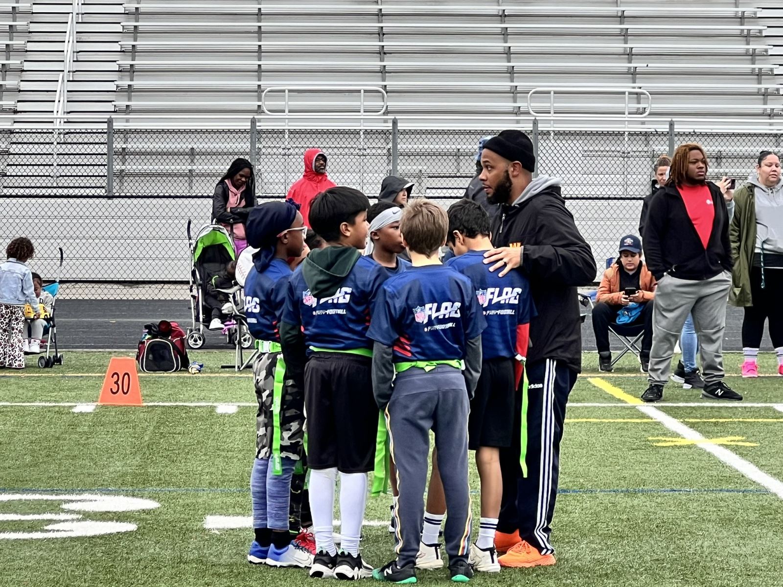 youth flag football team in huddle